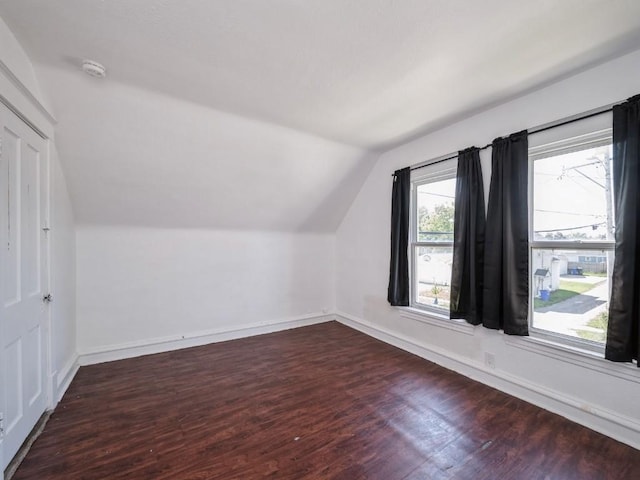 280 14th Ave SW, Cedar Rapids, IA 52404 - additional living space with vaulted ceiling, dark wood-type flooring, and baseboards