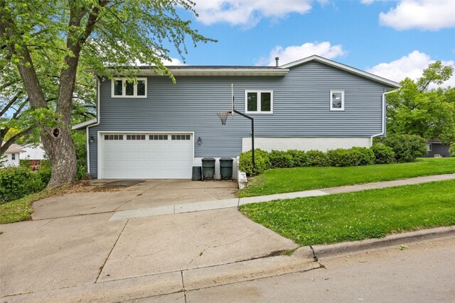 2536 N Ave NW, Cedar Rapids, IA 52405 - view of front of property with a garage, concrete driveway, and a front lawn
