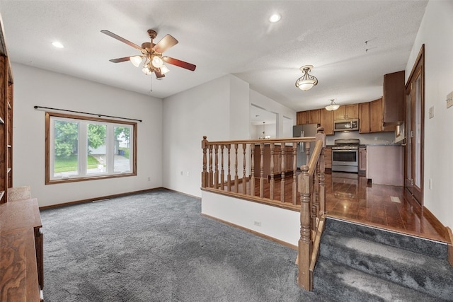 2536 N Ave NW, Cedar Rapids, IA 52405 - unfurnished living room with carpet floors, ceiling fan, baseboards, and recessed lighting