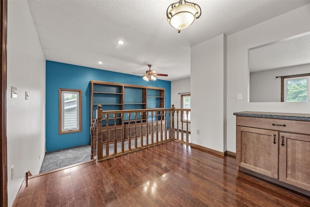 2536 N Ave NW, Cedar Rapids, IA 52405 - spare room with ceiling fan, dark wood-style floors, recessed lighting, baseboards, and a textured ceiling