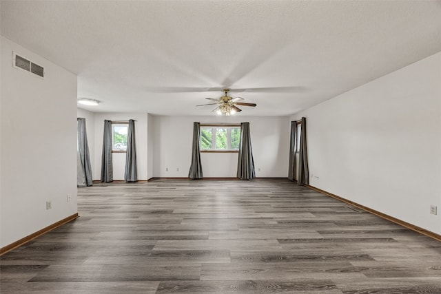 2536 N Ave NW, Cedar Rapids, IA 52405 - spare room featuring a ceiling fan, healthy amount of natural light, baseboards, and wood finished floors