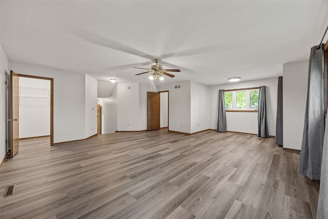 2536 N Ave NW, Cedar Rapids, IA 52405 - unfurnished living room featuring a ceiling fan, light wood-style flooring, and baseboards
