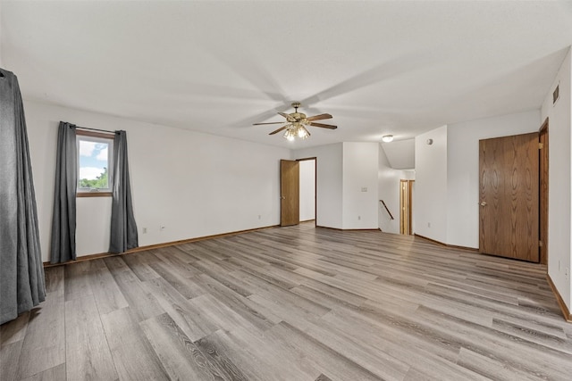 2536 N Ave NW, Cedar Rapids, IA 52405 - unfurnished room with light wood-type flooring, a ceiling fan, and baseboards