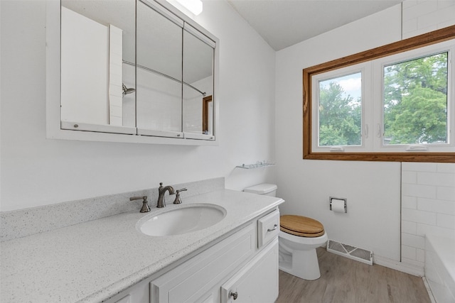 2536 N Ave NW, Cedar Rapids, IA 52405 - bathroom with toilet, a bath, vanity, wood finished floors, and a shower