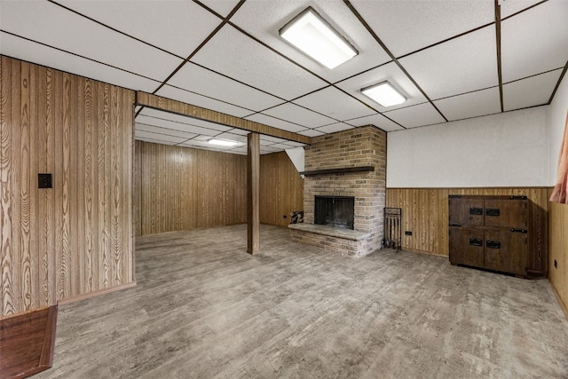 2536 N Ave NW, Cedar Rapids, IA 52405 - finished below grade area featuring a paneled ceiling, wood walls, a fireplace, wood finished floors, and a wainscoted wall