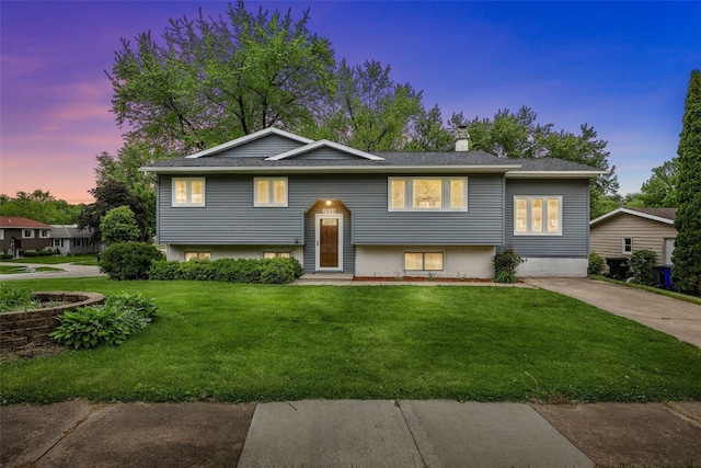 2536 N Ave NW, Cedar Rapids, IA 52405 - bi-level home featuring a front lawn and a chimney