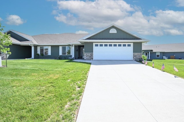 3902 Bluebird Dr SW, Cedar Rapids, IA 52404 - ranch-style house featuring an attached garage, a front yard, driveway, and stone siding