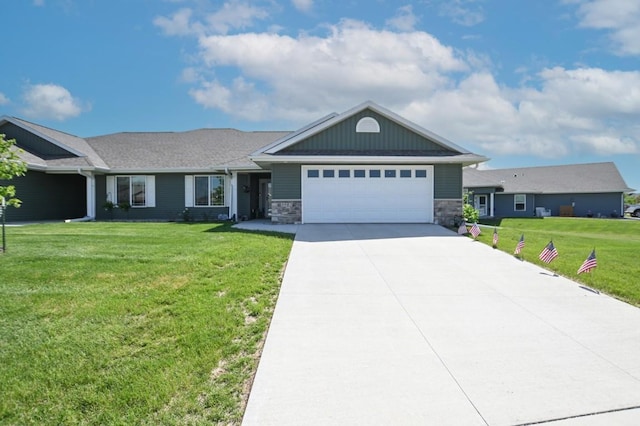 3902 Bluebird Dr SW, Cedar Rapids, IA 52404 - ranch-style house featuring an attached garage, driveway, a front yard, and stone siding