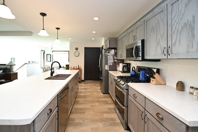 3902 Bluebird Dr SW, Cedar Rapids, IA 52404 - kitchen featuring appliances with stainless steel finishes, a sink, light wood-type flooring, light countertops, and recessed lighting