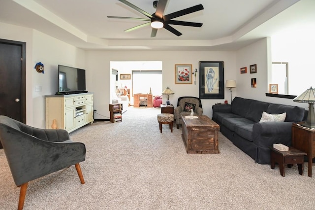 3902 Bluebird Dr SW, Cedar Rapids, IA 52404 - carpeted living area featuring a tray ceiling and ceiling fan