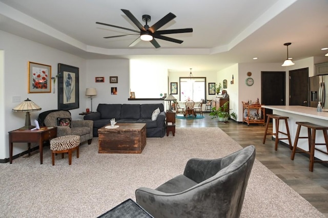 3902 Bluebird Dr SW, Cedar Rapids, IA 52404 - living area with a raised ceiling, ceiling fan, and wood finished floors