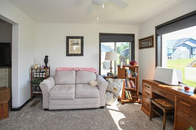 3902 Bluebird Dr SW, Cedar Rapids, IA 52404 - living area featuring carpet flooring, a ceiling fan, and a desk