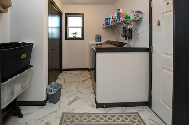 3902 Bluebird Dr SW, Cedar Rapids, IA 52404 - laundry area featuring light marble finish flooring, washer and clothes dryer, and baseboards