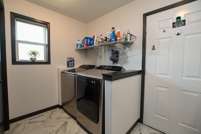 3902 Bluebird Dr SW, Cedar Rapids, IA 52404 - laundry room with light marble finish flooring, washer and dryer, and baseboards