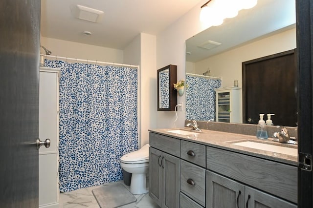 3902 Bluebird Dr SW, Cedar Rapids, IA 52404 - bathroom with double vanity, toilet, marble look tile flooring, and a shower with shower curtain