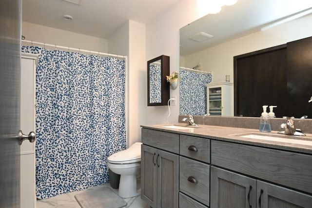 3902 Bluebird Dr SW, Cedar Rapids, IA 52404 - bathroom featuring double vanity, toilet, a shower with curtain, and marble finish floors