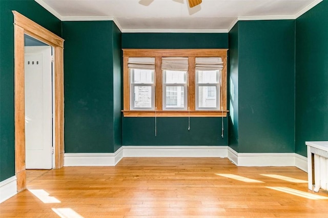 384 21st St SE, Cedar Rapids, IA 52403 - unfurnished room featuring hardwood / wood-style floors, a ceiling fan, baseboards, and crown molding