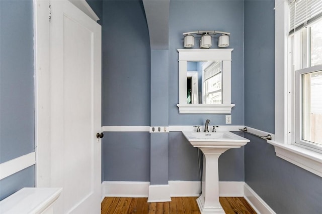 384 21st St SE, Cedar Rapids, IA 52403 - half bathroom featuring baseboards and wood finished floors