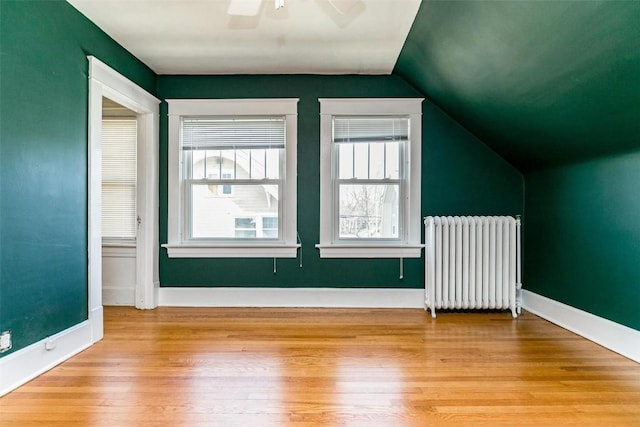 384 21st St SE, Cedar Rapids, IA 52403 - bonus room featuring radiator heating unit, lofted ceiling, light wood-style flooring, a ceiling fan, and baseboards