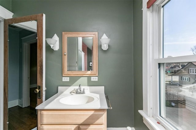 384 21st St SE, Cedar Rapids, IA 52403 - bathroom featuring vanity, baseboards, and healthy amount of natural light
