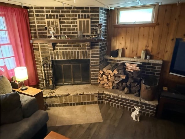 101 26th Avenue Dr SW, Cedar Rapids, IA 52404 - living area featuring a fireplace, wood walls, wood finished floors, and healthy amount of natural light