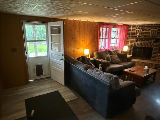 101 26th Avenue Dr SW, Cedar Rapids, IA 52404 - living area featuring plenty of natural light, wood walls, a fireplace, and wood finished floors