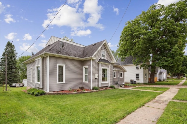 311 3rd St S, Coggon, IA 52218 - view of front of property with a front yard and a shingled roof