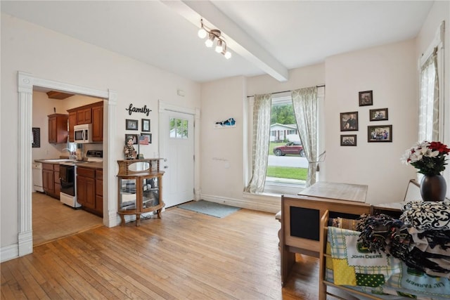 311 3rd St S, Coggon, IA 52218 - interior space with light wood finished floors, baseboards, and beamed ceiling