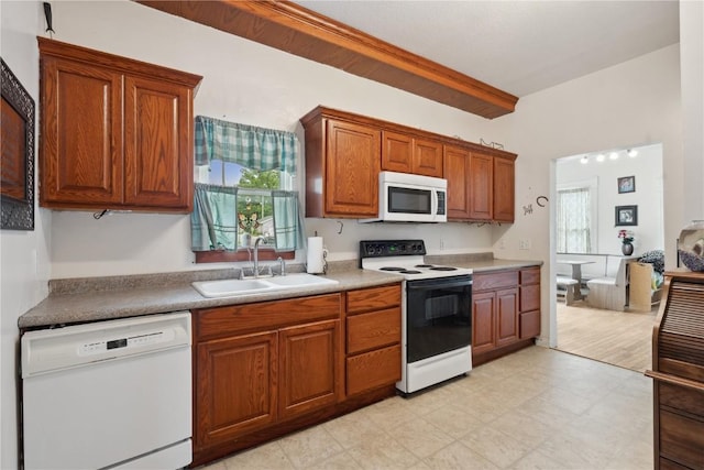 311 3rd St S, Coggon, IA 52218 - kitchen with white appliances, a sink, brown cabinetry, and light flooring