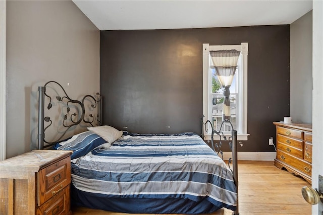 311 3rd St S, Coggon, IA 52218 - bedroom featuring light wood-type flooring and baseboards