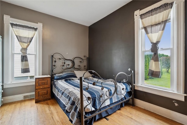311 3rd St S, Coggon, IA 52218 - bedroom featuring light wood-style floors and baseboards