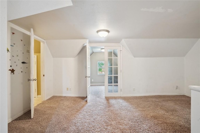 311 3rd St S, Coggon, IA 52218 - bonus room with carpet floors, lofted ceiling, and baseboards