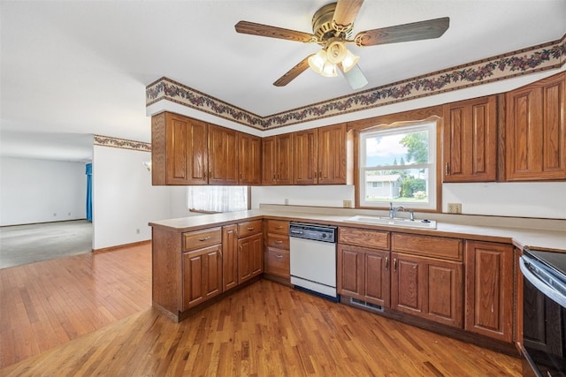 1083 Rainbow Blvd, Hiawatha, IA 52233 - kitchen featuring dishwasher, a sink, a peninsula, wood finished floors, and range with electric stovetop
