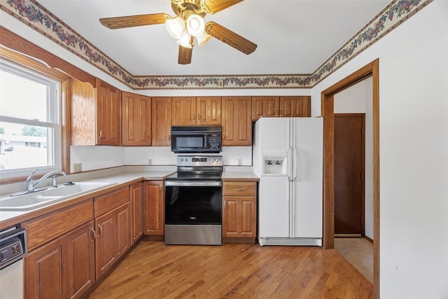 1083 Rainbow Blvd, Hiawatha, IA 52233 - kitchen with white fridge with ice dispenser, black microwave, electric stove, a sink, and dishwashing machine