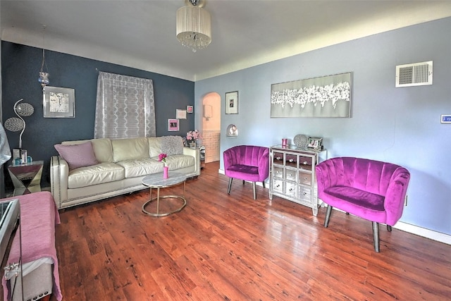 361 30th St SE, Cedar Rapids, IA 52403 - living room featuring arched walkways and wood finished floors