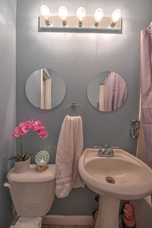 361 30th St SE, Cedar Rapids, IA 52403 - bathroom featuring toilet and a sink