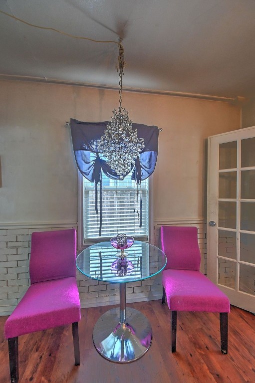 361 30th St SE, Cedar Rapids, IA 52403 - living area with wood finished floors and a chandelier