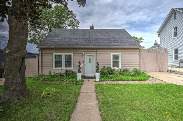 361 30th St SE, Cedar Rapids, IA 52403 - view of front of home with roof with shingles and a chimney