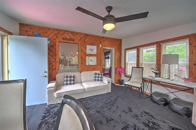 361 30th St SE, Cedar Rapids, IA 52403 - living area featuring ceiling fan, wooden walls, and carpet
