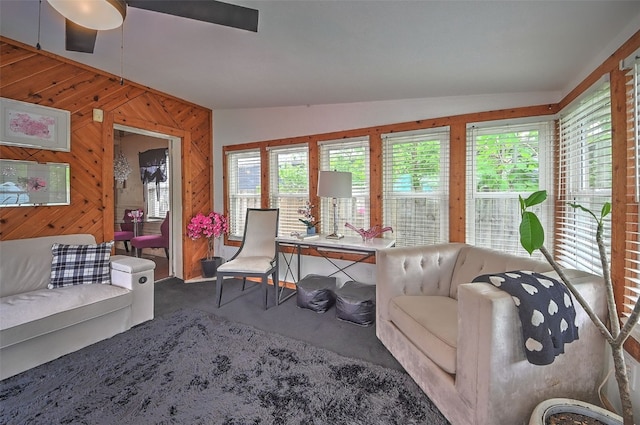 361 30th St SE, Cedar Rapids, IA 52403 - carpeted living room featuring wood walls