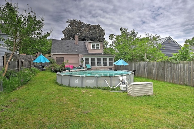 361 30th St SE, Cedar Rapids, IA 52403 - rear view of house featuring a sunroom and a chimney