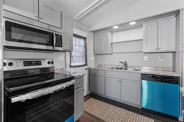 840 S Dubuque St, Solon, IA 52333 - kitchen with appliances with stainless steel finishes, a sink, dark wood-type flooring, vaulted ceiling, and gray cabinets