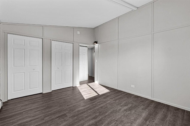 840 S Dubuque St, Solon, IA 52333 - unfurnished bedroom featuring dark wood finished floors