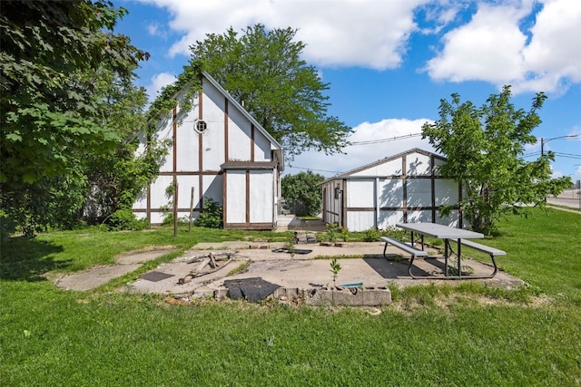 87 14th Ave SW, Cedar Rapids, IA 52404 - rear view of property featuring a lawn, stucco siding, and an outdoor structure