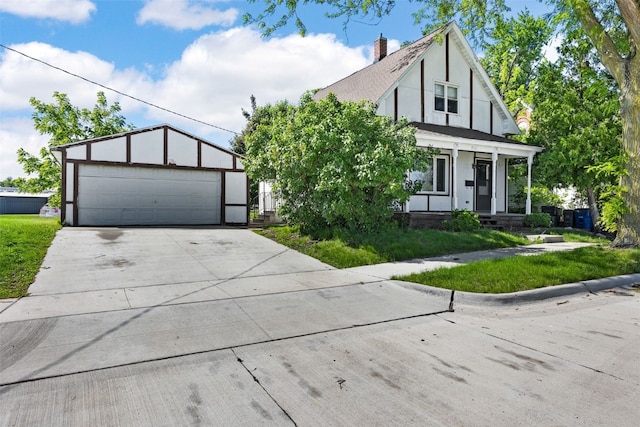 87 14th Ave SW, Cedar Rapids, IA 52404 - tudor house with stucco siding, a garage, and covered porch
