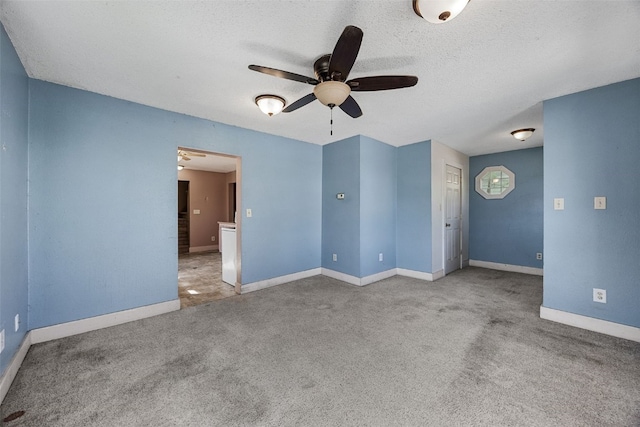 87 14th Ave SW, Cedar Rapids, IA 52404 - carpeted empty room featuring ceiling fan, baseboards, and a textured ceiling
