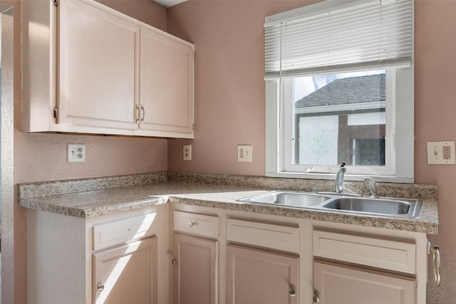 87 14th Ave SW, Cedar Rapids, IA 52404 - kitchen featuring a sink and light countertops