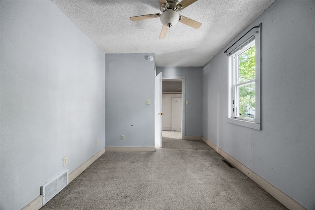 87 14th Ave SW, Cedar Rapids, IA 52404 - spare room featuring a textured ceiling, ceiling fan, and carpet floors