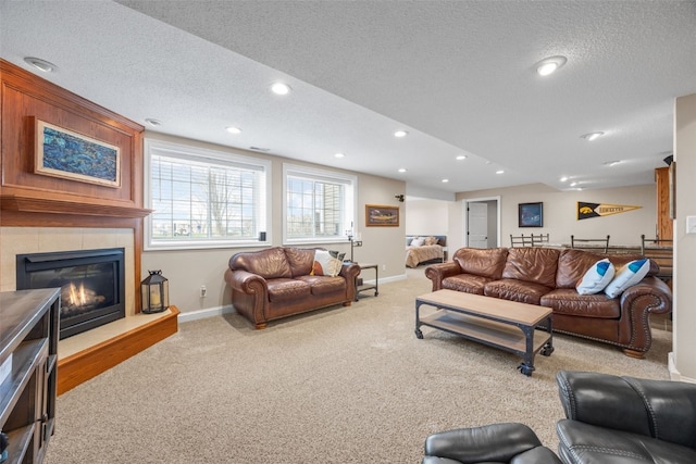 2545 Silver Oak Trl, Marion, IA 52302 - carpeted living area with baseboards, a textured ceiling, a tile fireplace, and recessed lighting