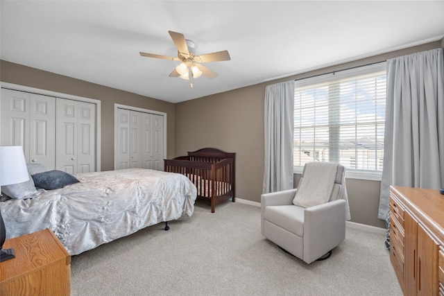 2545 Silver Oak Trl, Marion, IA 52302 - bedroom with multiple closets, light colored carpet, and baseboards